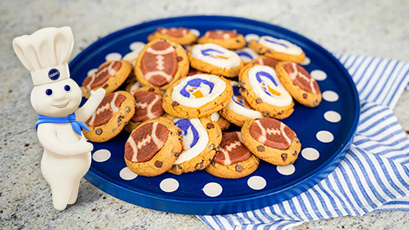 Cookies on a blue color plate with pillsbury dough boy on left. 