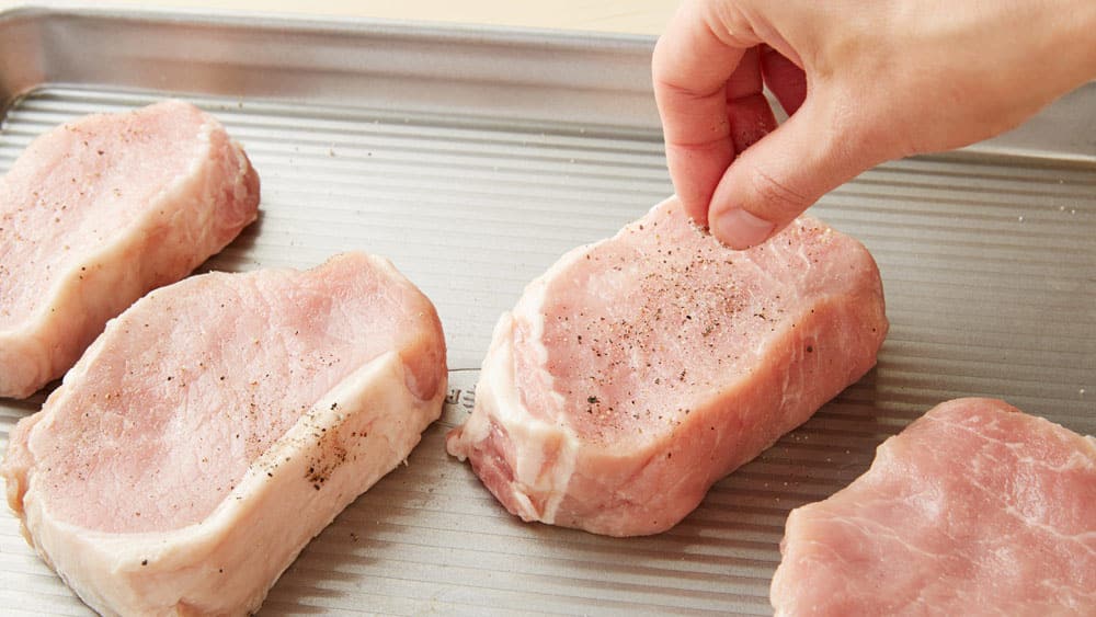 Sprinkle both pork chops with salt and pepper