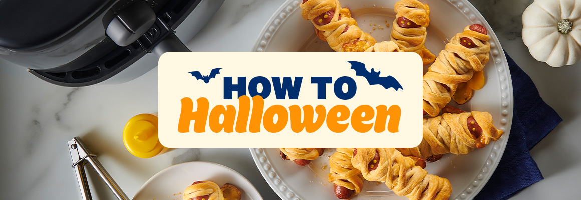 How to Halloween - crescent mummy dogs on a white plate next to an air fryer and white pumpkin