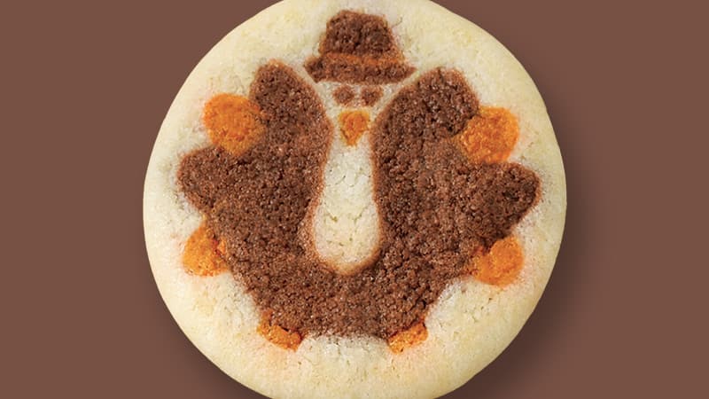 A Thanksgiving cookie with a turkey decoration.