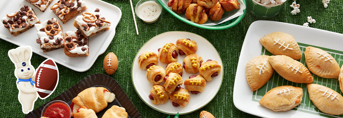 An assortment of sports-themed snacks including chocolate pretzel bars, sausage rolls, and crescent rolls. 